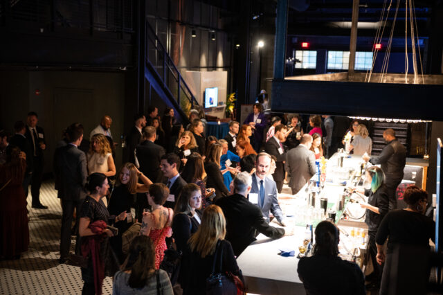 Guests at CDT's 2022 Tech Prom mix and mingle at the bar.