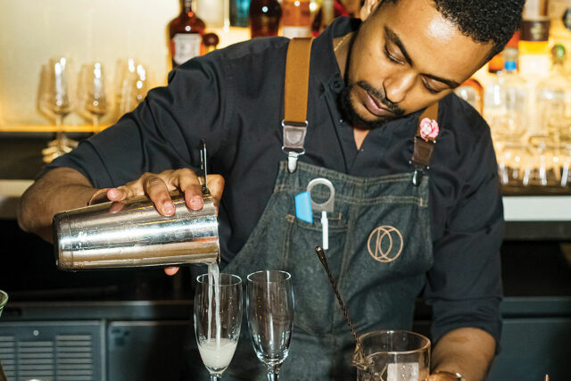 A picture of a bartender mixing a drink at CDT's 2023 Spring Fling.