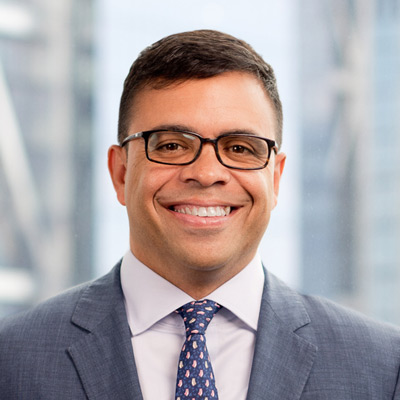 Debo Adegbile. Partner, Wilmer Cutler Pickering Hale and Dorr LLP. Wearing glasses and a great suit with a white shirt.