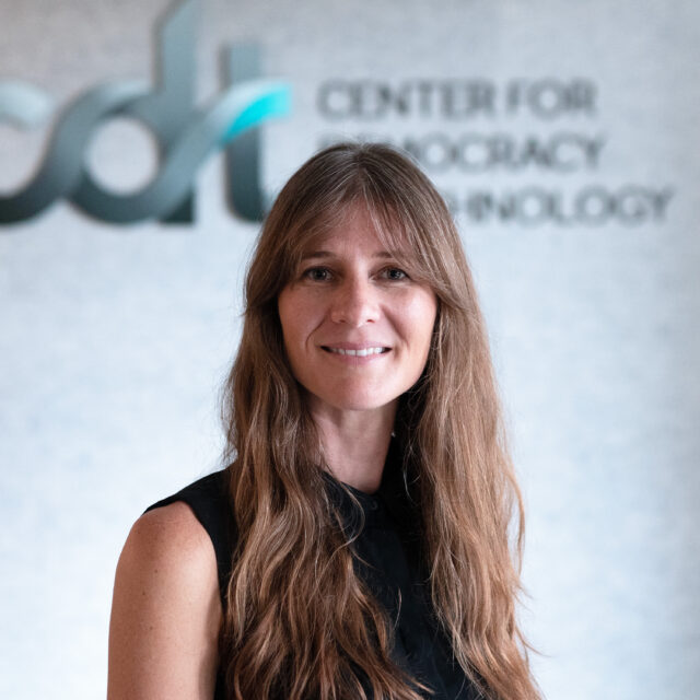 Mallory Knodel, wearing a black top and smiling in front of a CDT logo.