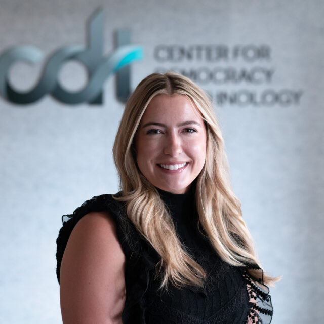 Maddy Dwyer, in a black top smiling in front of a CDT logo.