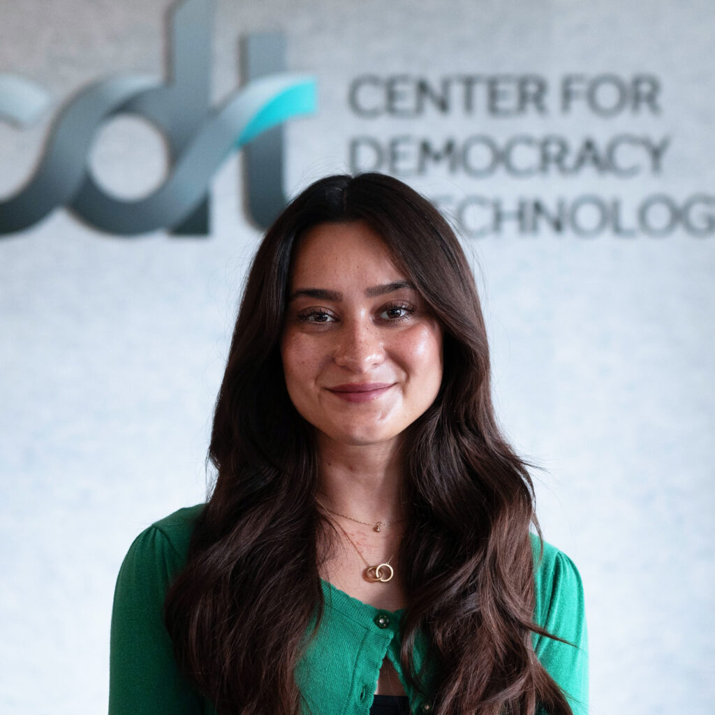 Kristin Woelfel, smiling in a green top.
