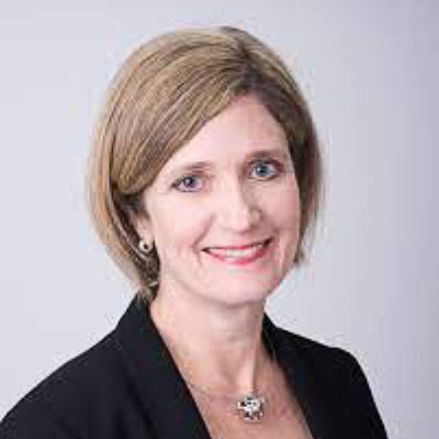 Cathy Feingold. AFL-CIO. Wearing a dark colored suit in front of a light colored backdrop.