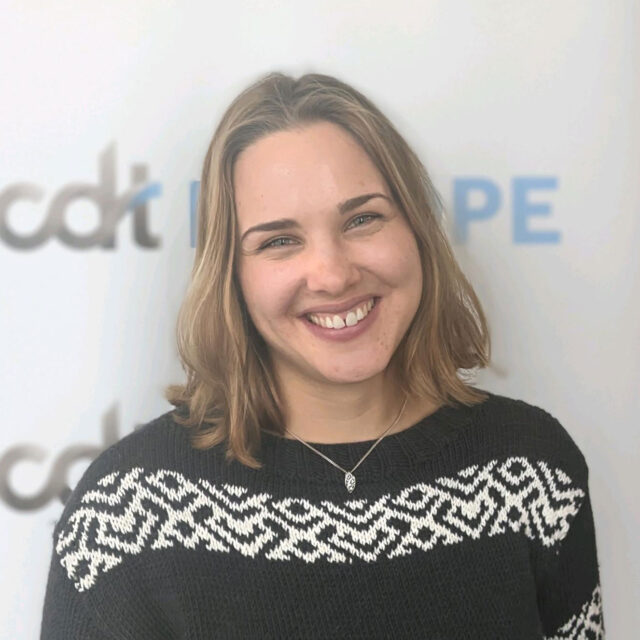 Magdalena Maier, smiling wearing a patterned sweater, in front of a CDT Europe backdrop.