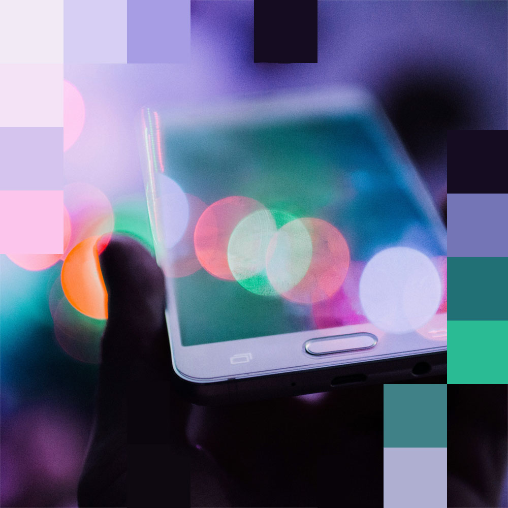 Pixelated photo of a hand holding a phone.