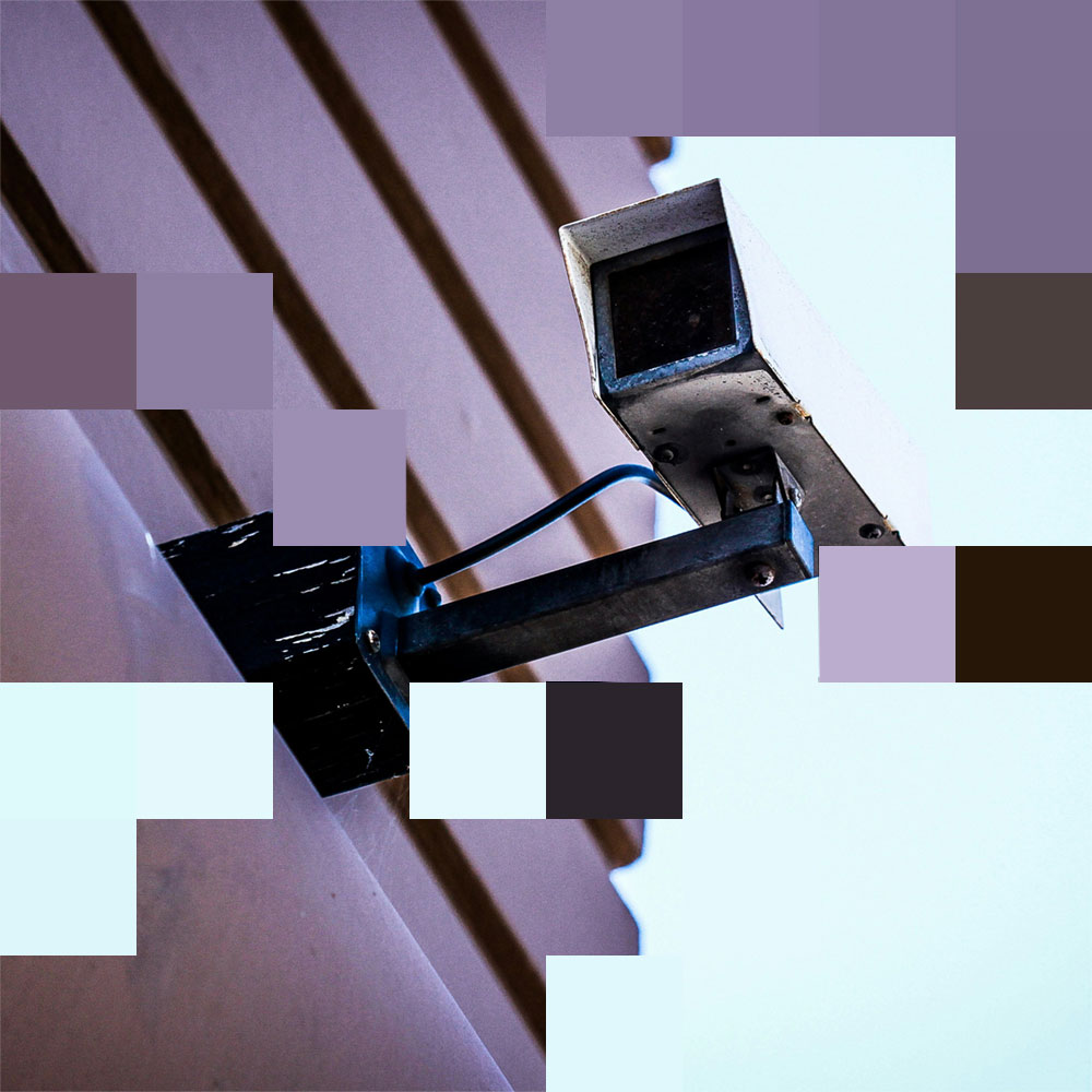 Pixelated of a security CC TV camera, mounted on an exterior wall.