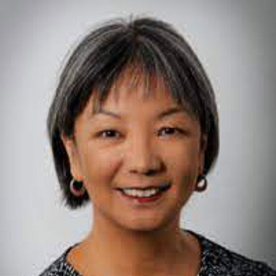 Corrine Yu. Leadership Conference on Civil and Human Rights. Wearing a grey shirt in front of a light grey backdrop.