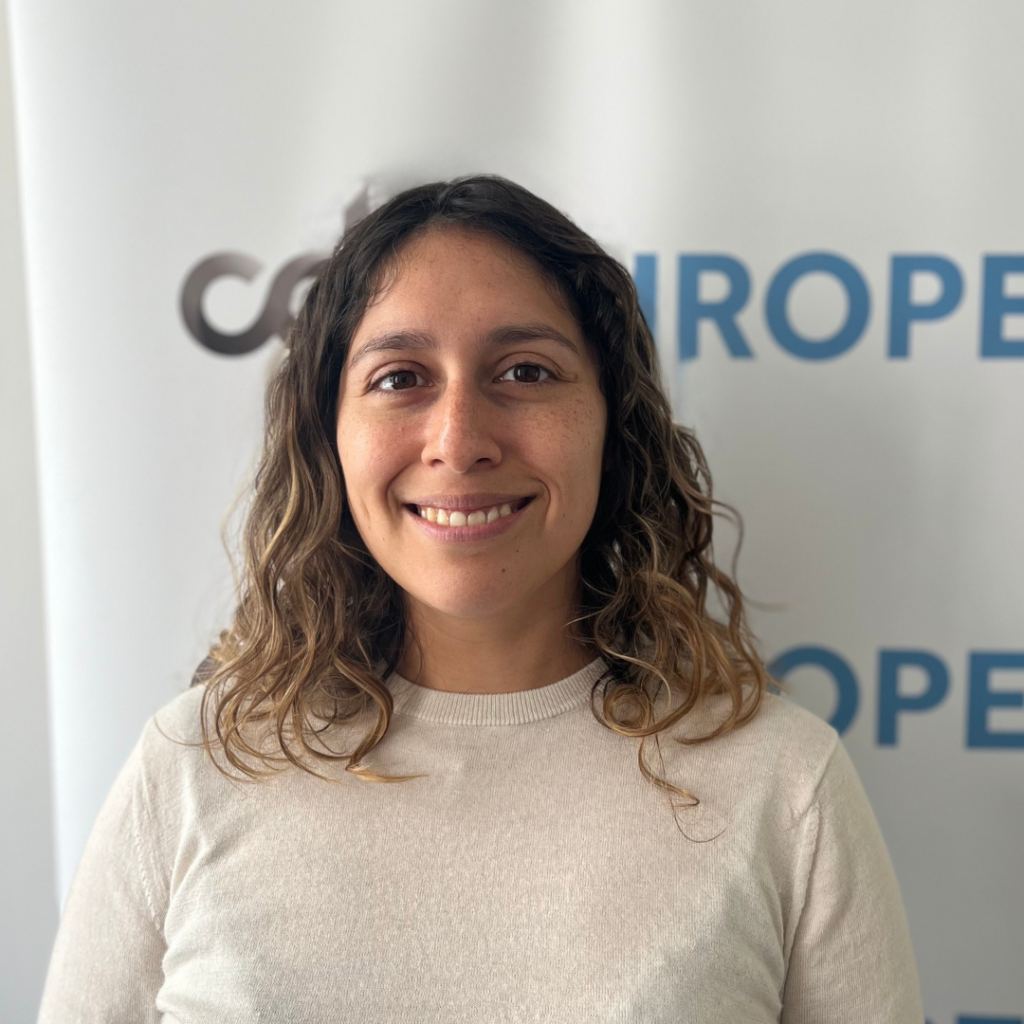Laura Lazaro Cabrera, smiling in a light colored top in front of a CDT Europe backdrop.